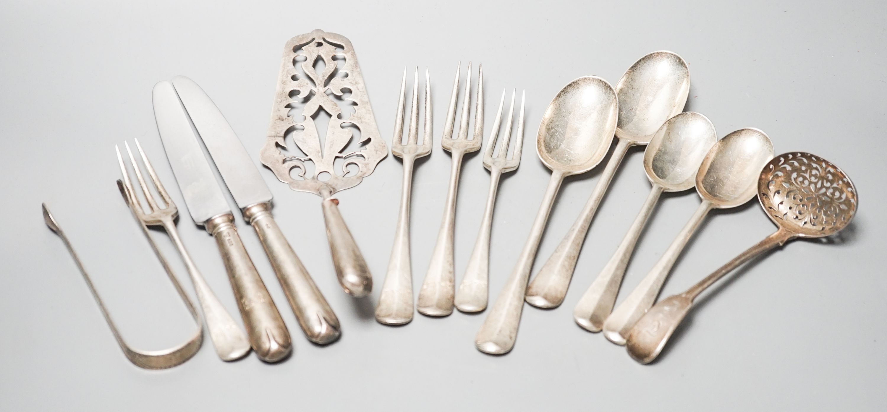 Mixed flatware including a Georgian silver sifter spoon, white metal cake slice, silver three pronged forks etc.